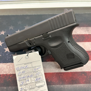 Glock semi-automatic pistol displayed on a firearm sales counter with a product tag at Old Town Tactical.