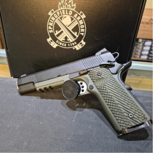 Springfield Armory 1911-style semi-automatic pistol displayed in front of a Springfield Armory case at Old Town Tactical.