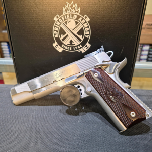 Springfield Armory stainless 1911-style semi-automatic pistol with wood-textured grips displayed in front of a Springfield Armory case at Old Town Tactical.
